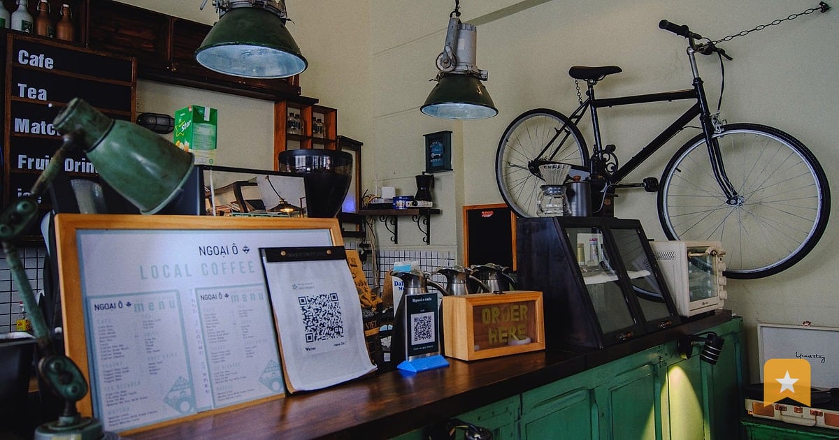 Coffee shop counter with QR code sign and menu, showing how a local business invites customer feedback